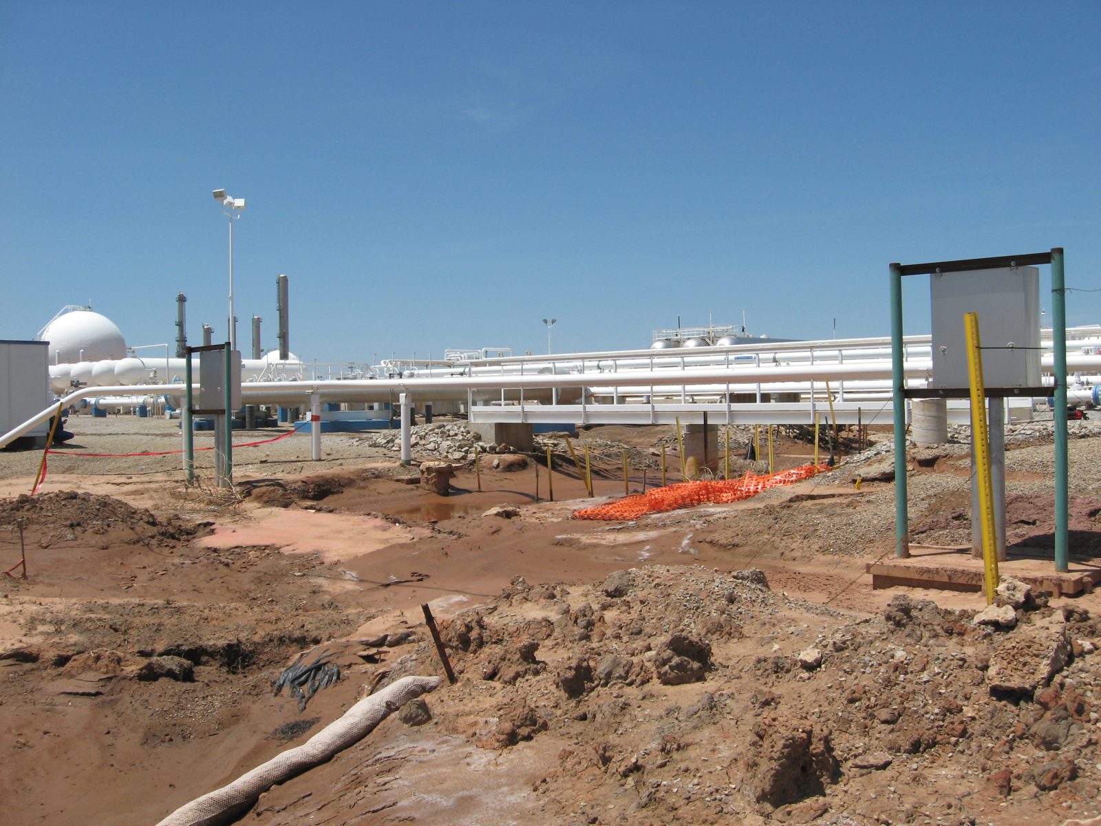 Before: Eroded drainage beneath pipe racks at a processing plant